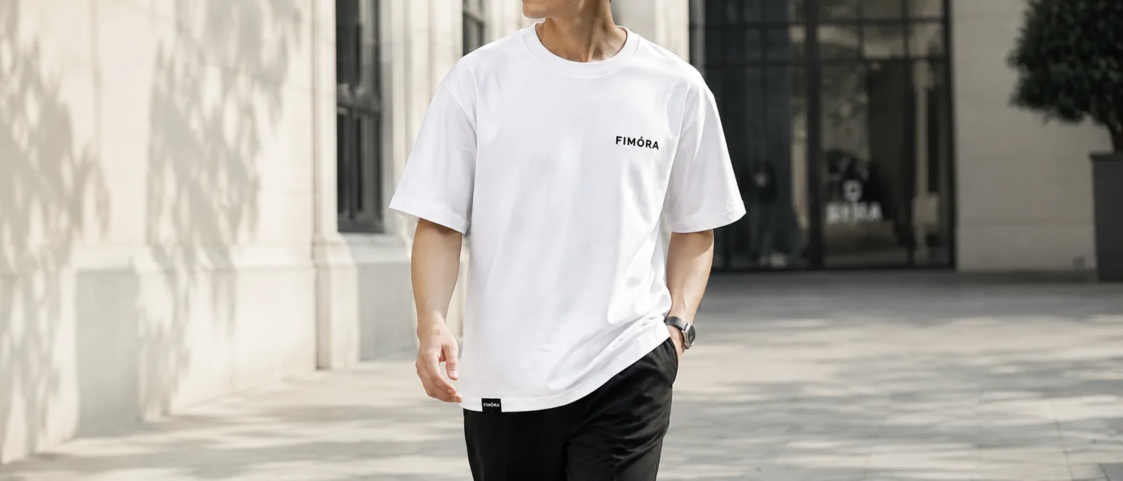 Male model wearing FIMÓRA white T-shirt in natural light